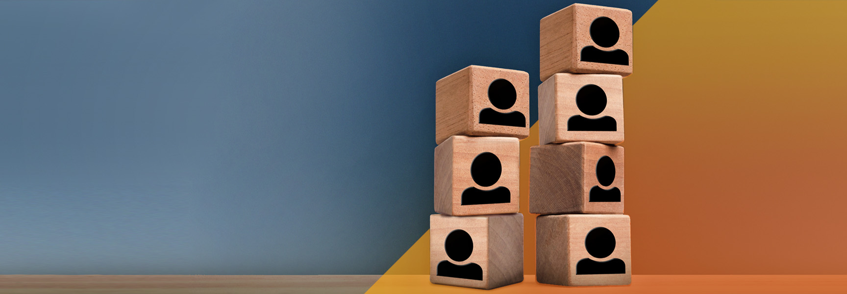 Wooden blocks with black user icons stacked in two uneven columns on a surface. The background has a color gradient from blue to orange.